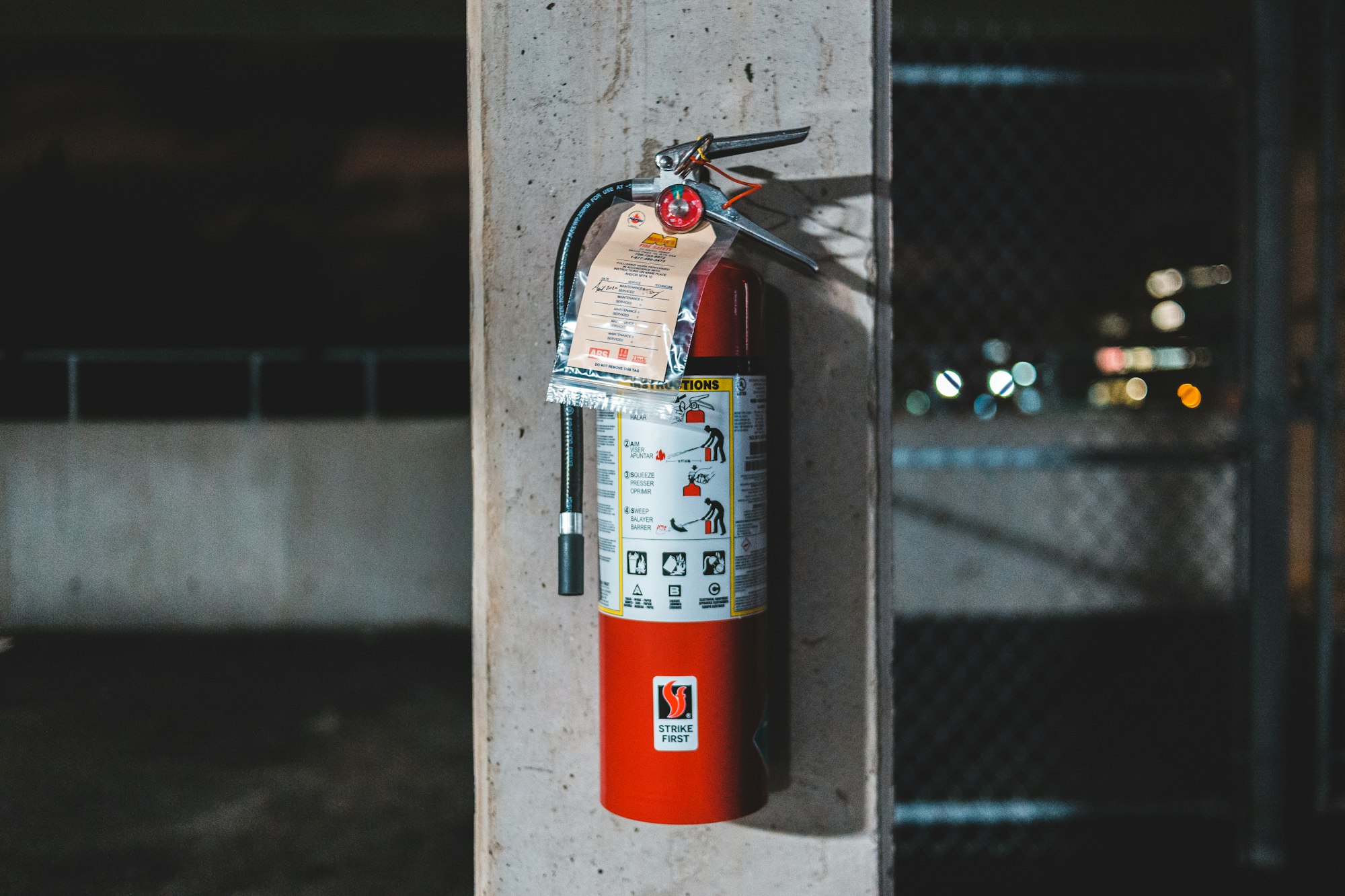 A tagged fire extinguisher on a concrete column
