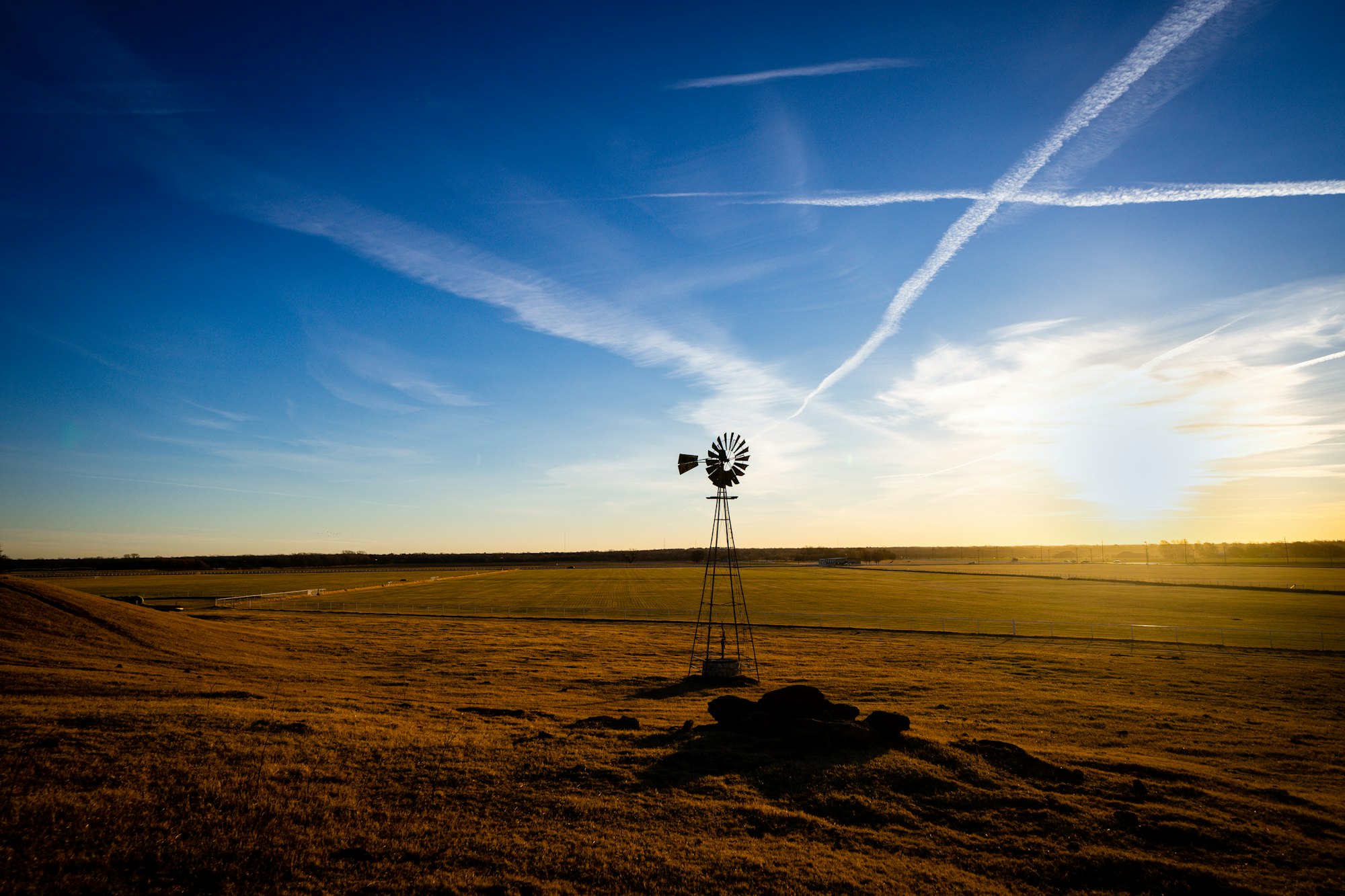 A windmill on the Texas plains at sunset